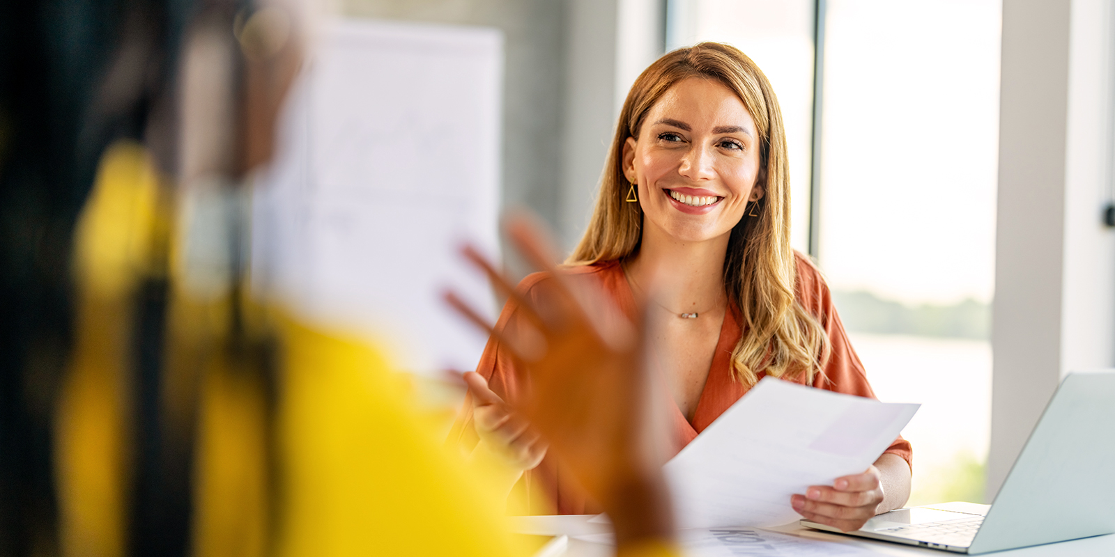 Les avantages de l'externalisation des titres de paiement avec Numen. Image d'une RH souriante avec un salarié en réunion